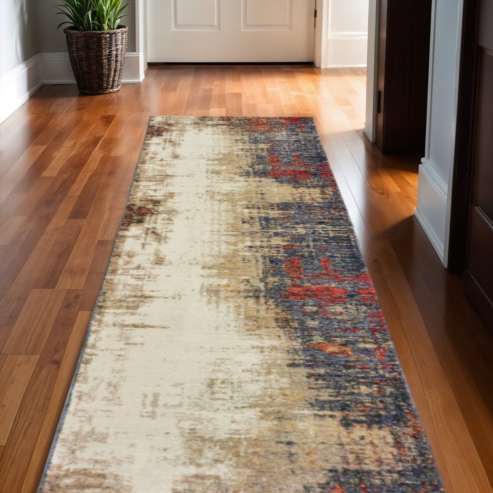 Distressed abstract area rug runner in cream with blue and orange accents on hardwood hallway floor.