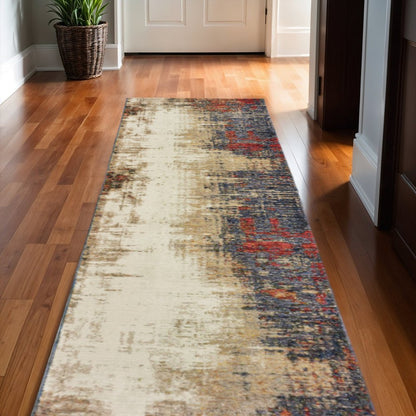 Distressed abstract area rug runner in cream with blue and orange accents on hardwood hallway floor.