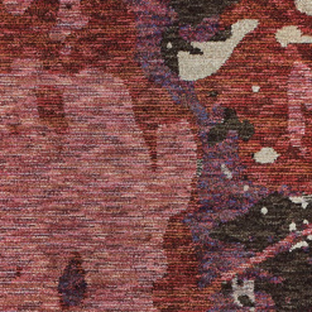 Red-pink patterned woven runner rug with purple, black and white accents.