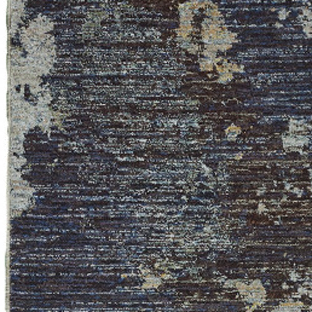 Navy blue abstract distressed runner rug with beige patches and woven texture.