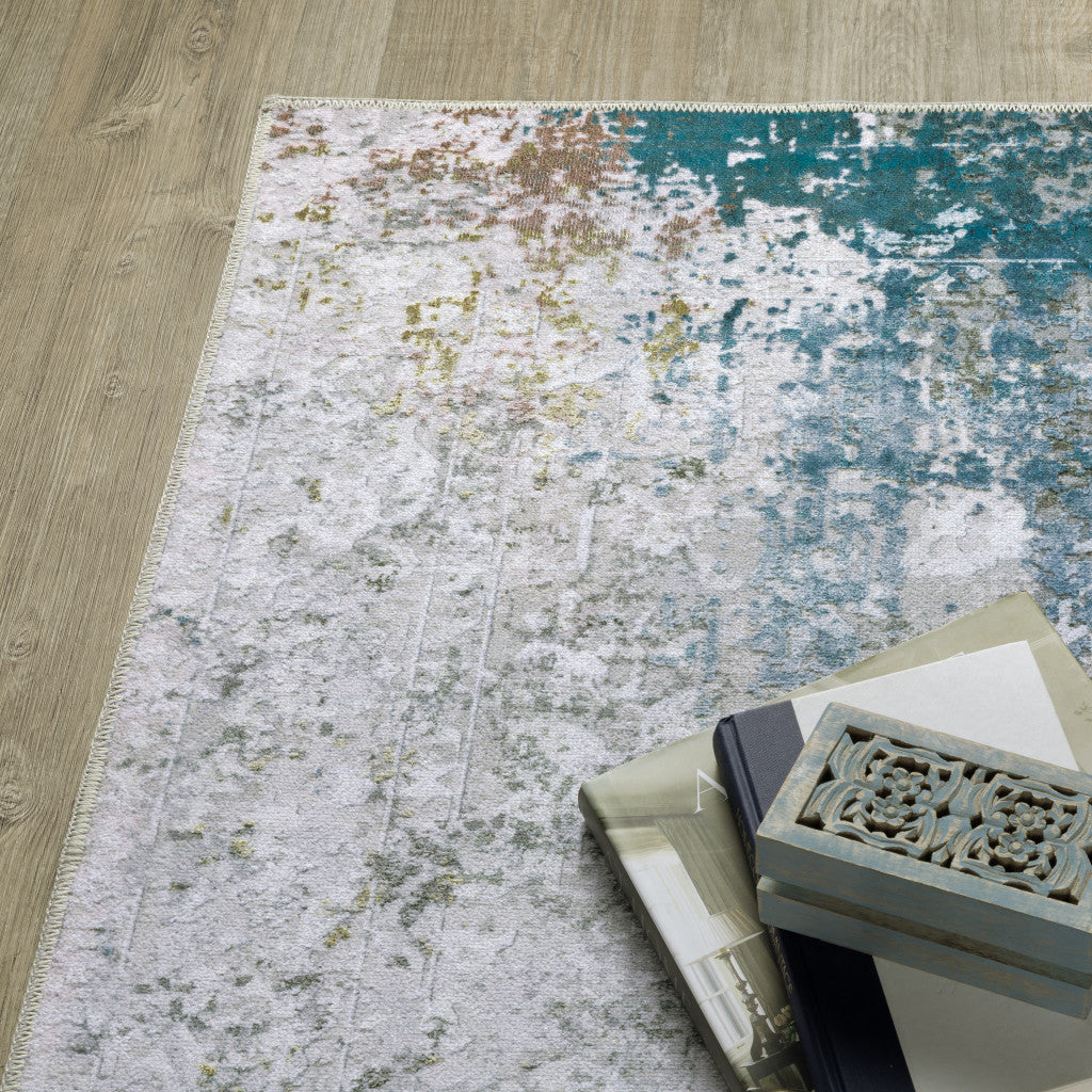 5' X 7' Ivory Teal Blue Grey Brown And Gold Abstract Printed Stain Resistant Non Skid Area Rug
