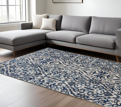 10' X 14' Blue Ivory And Black Floral Distressed Stain Resistant Area Rug