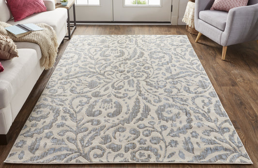 5' X 8' Blue Ivory And Tan Floral Distressed Stain Resistant Area Rug