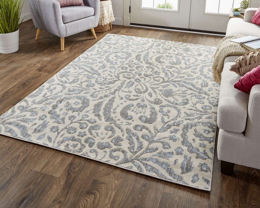 10' X 14' Blue Ivory And Tan Floral Distressed Stain Resistant Area Rug