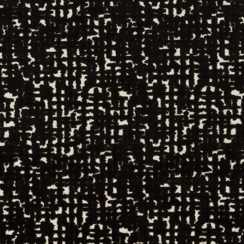 Black and beige speckled fabric texture with an irregular grid-like abstract pattern.