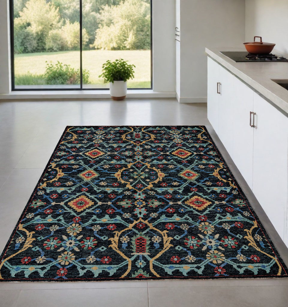 4' X 6' Blue Yellow And Red Wool Floral Hand Knotted Distressed Stain Resistant Area Rug With Fringe