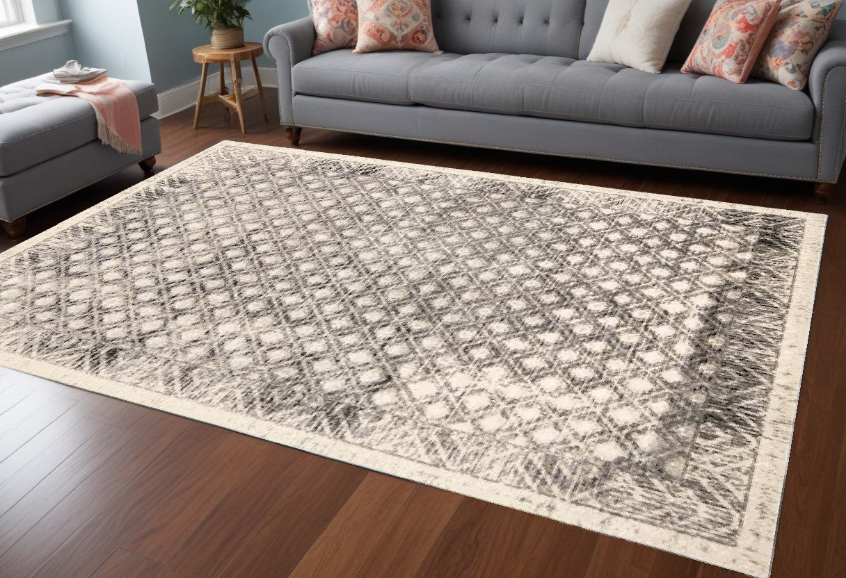 5' X 8' Ivory and Black Abstract Geometric Area Rug