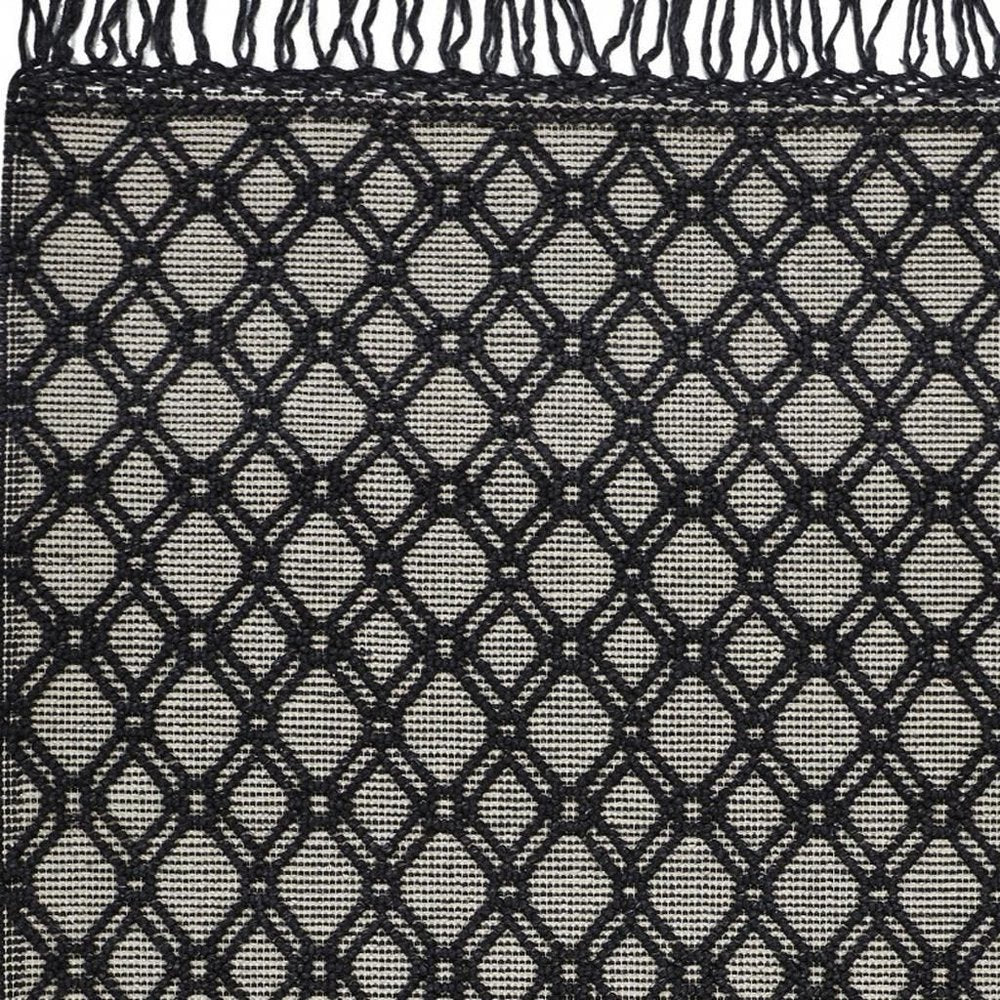 5' X 8' Black And Ivory Wool Geometric Hand Woven Area Rug With Fringe