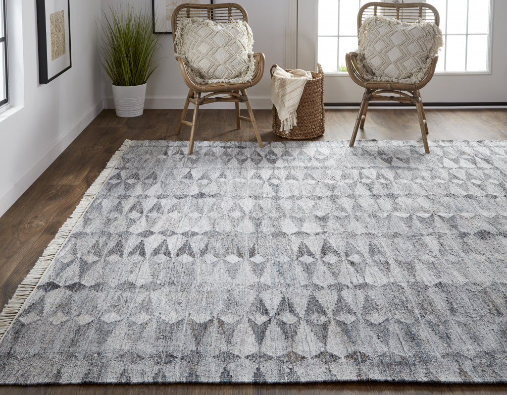 4' X 6' Gray Silver And Ivory Geometric Hand Woven Stain Resistant Area Rug With Fringe