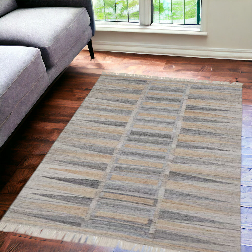 4' X 6' Tan Gray And Taupe Geometric Hand Woven Stain Resistant Area Rug With Fringe