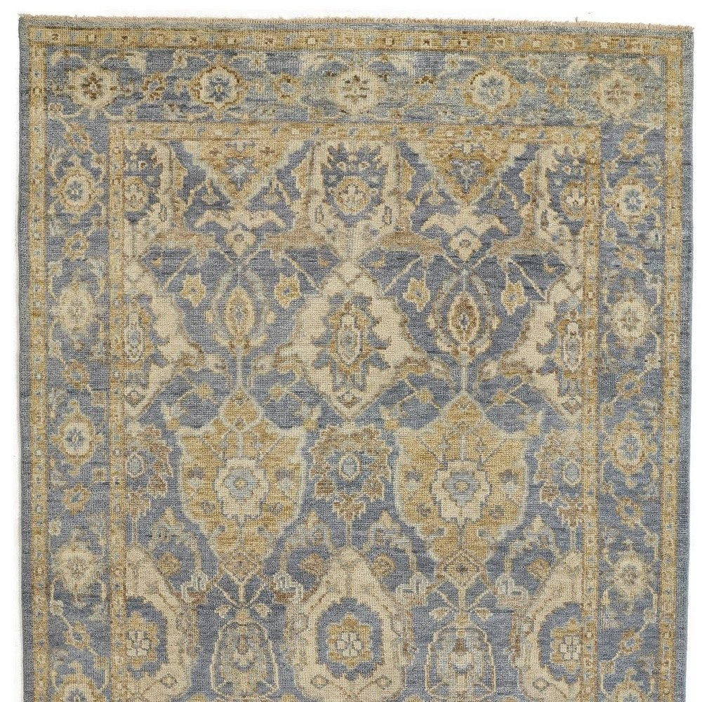 5' X 8' Blue Gold And Tan Wool Floral Hand Knotted Stain Resistant Area Rug With Fringe