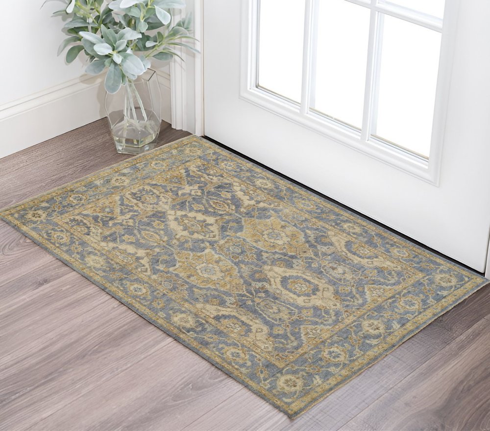 5' X 8' Blue Gold And Tan Wool Floral Hand Knotted Stain Resistant Area Rug With Fringe