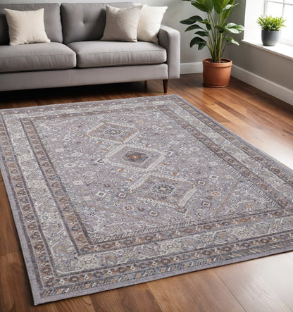 10' X 13' Gray Orange And Ivory Floral Power Loom Stain Resistant Area Rug