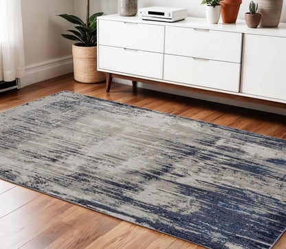 9' X 12' Tan Blue And Ivory Abstract Power Loom Distressed Area Rug