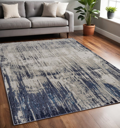4' X 6' Tan Blue And Ivory Abstract Power Loom Distressed Area Rug