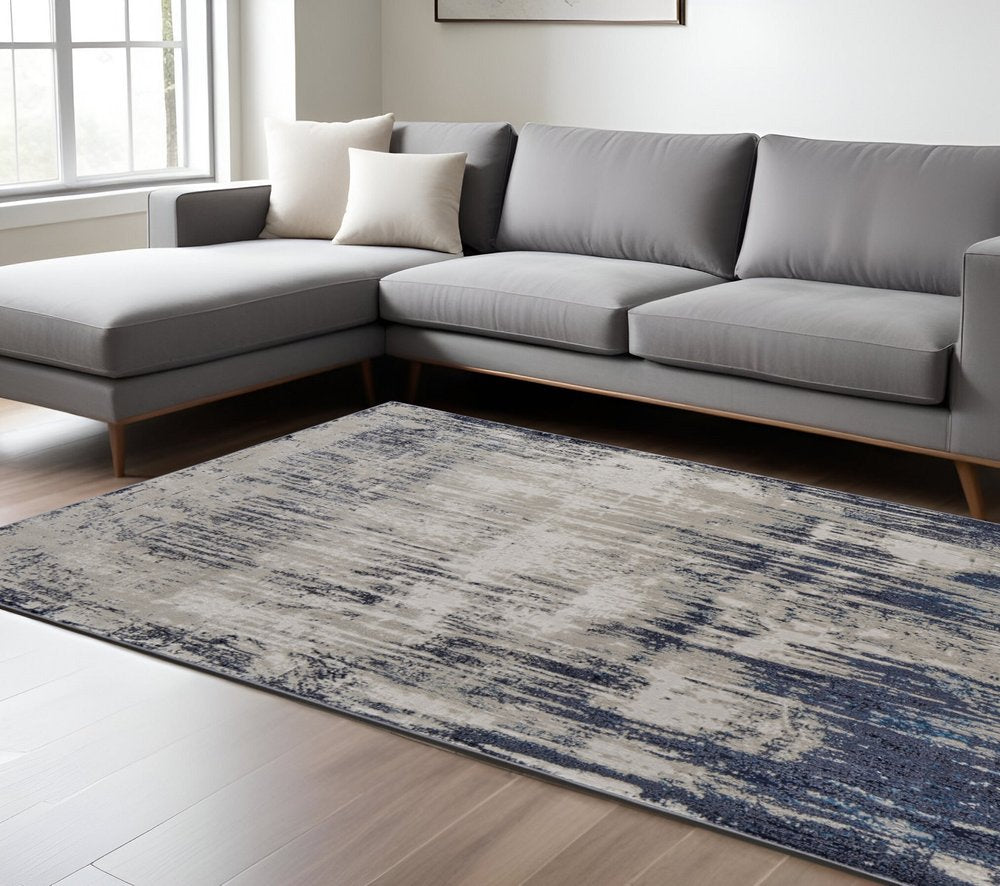 4' X 6' Tan Blue And Ivory Abstract Power Loom Distressed Area Rug