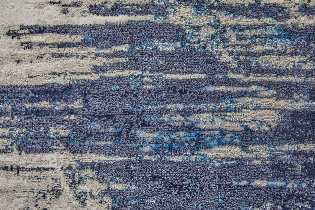 9' X 12' Tan Blue And Ivory Abstract Power Loom Distressed Area Rug