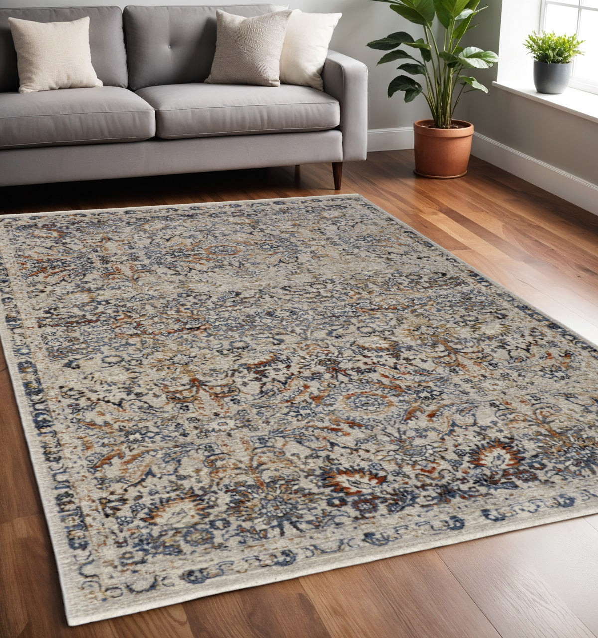 5' X 8' Tan and Blue Floral Power Loom Distressed Non Skid Area Rug With Fringe