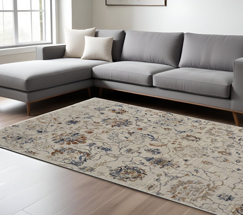 8' X 10' Ivory Blue And Burnt Orange Floral Distressed Area Rug With Fringe