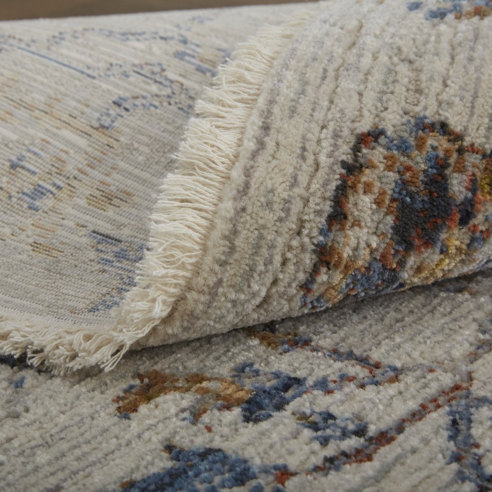 8' X 10' Ivory Blue And Burnt Orange Floral Distressed Area Rug With Fringe