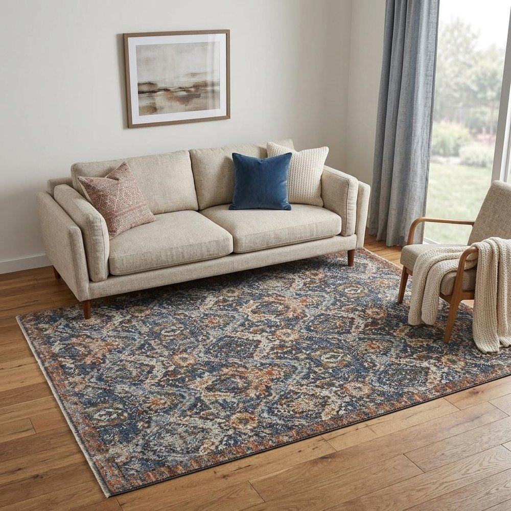 5' X 8' Ivory Blue And Burnt Orange Floral Area Rug With Fringe