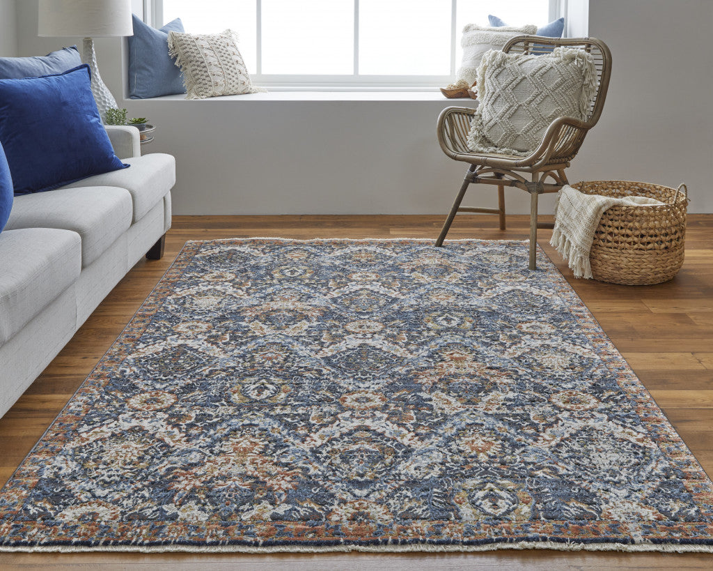 5' X 8' Blue Orange And Ivory Floral Power Loom Area Rug With Fringe