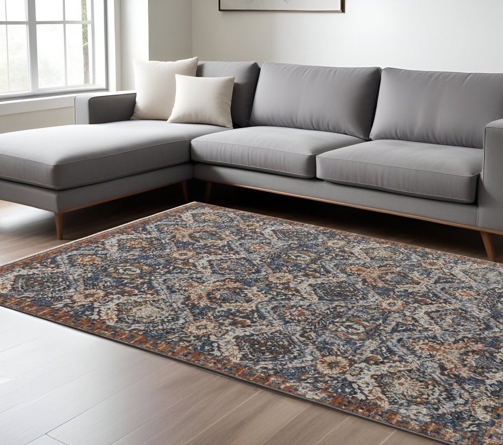 8' X 10' Ivory Blue And Burnt Orange Floral Area Rug With Fringe