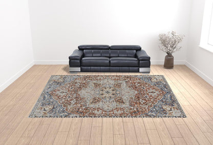 2' X 3' Burnt Orange Ivory And Blue Floral Area Rug With Fringe