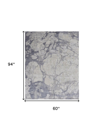 4' X 6' Ivory And Blue Abstract Power Loom Distressed Area Rug