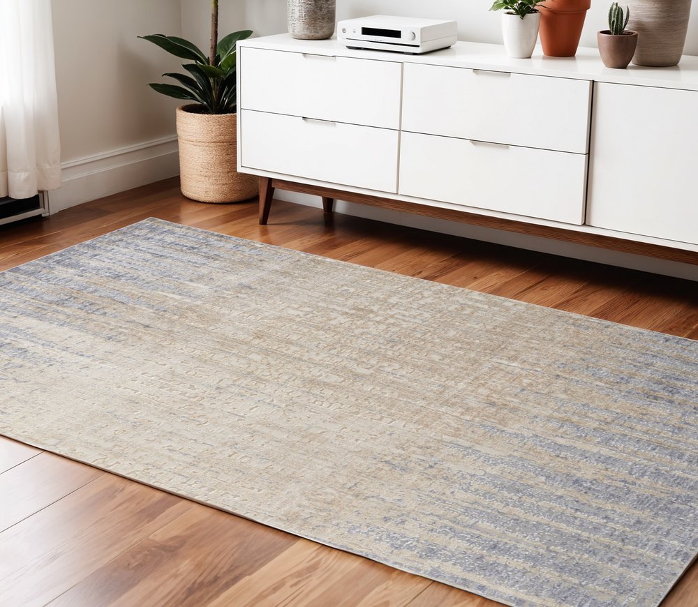 5' X 8' Tan And Blue Abstract Distressed Area Rug