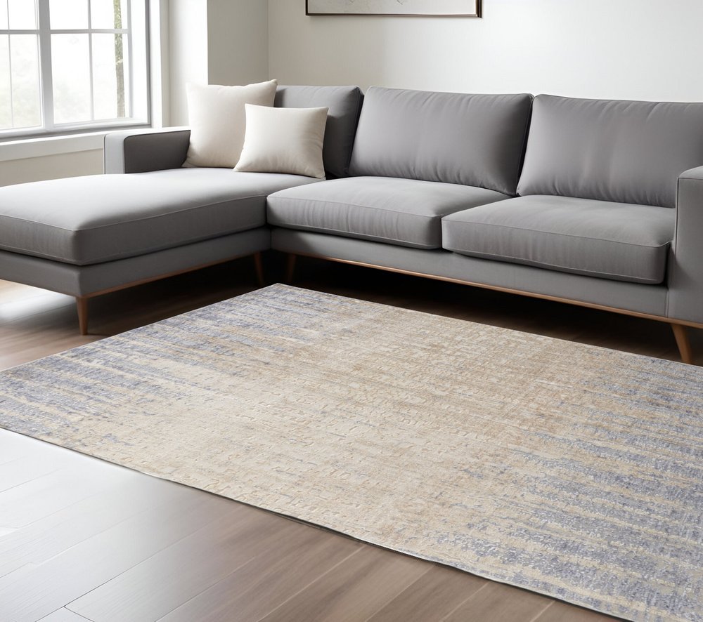 5' X 8' Tan And Blue Abstract Distressed Area Rug