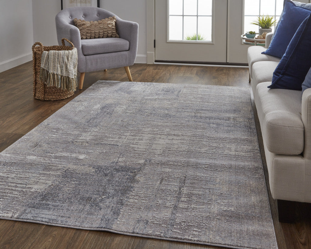 7' X 9' Taupe Tan And Blue Abstract Power Loom Distressed Stain Resistant Area Rug