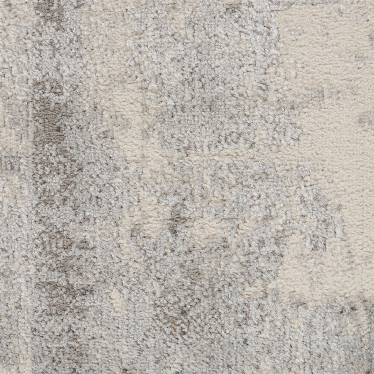 Neutral beige-gray abstract-pattern rug with a soft, plush pile and distressed texture.