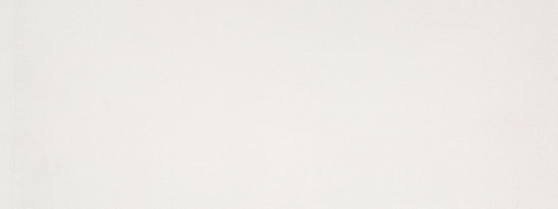 Soft pale cream textured drapery fabric with subtle shading; neutral backdrop.