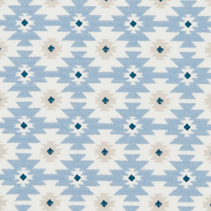 Aztec-inspired geometric pattern in light blue and white with navy diamond accents on textile.