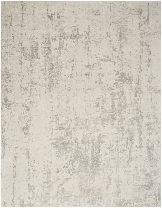 Rectangular light gray and ivory distressed area rug with a soft pile; modern, neutral decor.