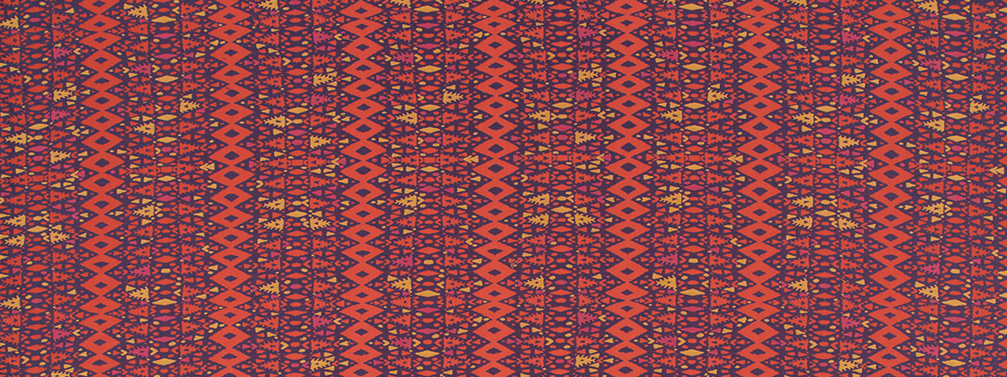 Close-up of orange-red woven textile with purple geometric diamonds and yellow accents in a kilim/tribal pattern.