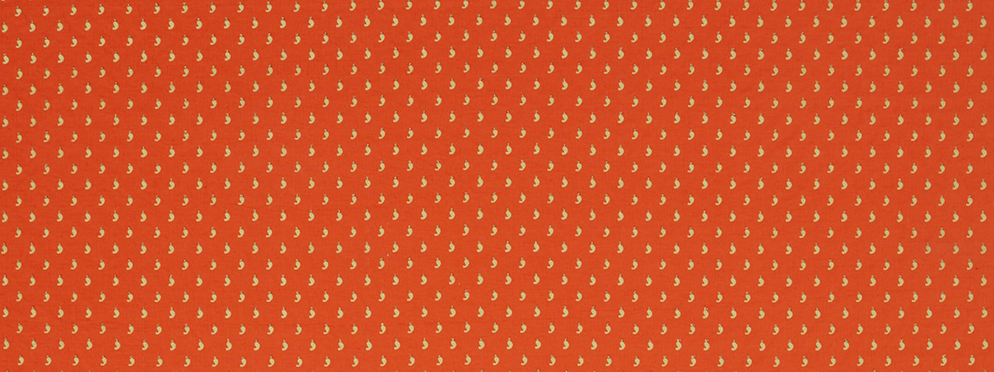 Orange-red fabric with tiny yellow leaf motifs in a dense repeating pattern; versatile textile for scarves or dresses.