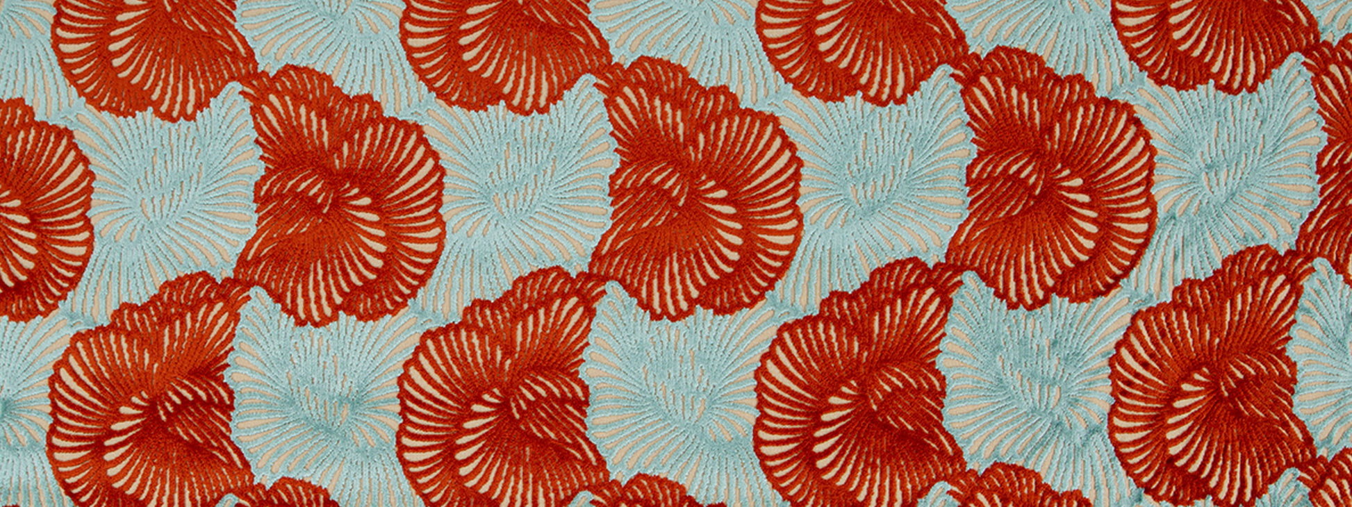 Two-tone embroidery: red circular rosette shapes on tomato fabric, textured floral pattern.