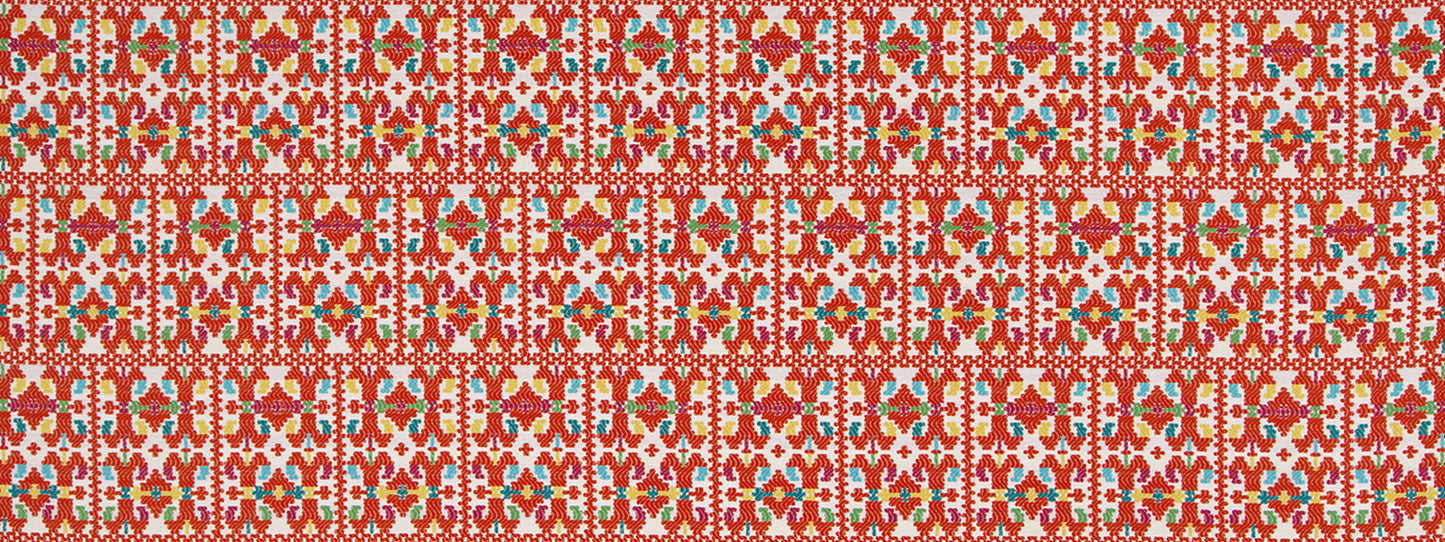 Red upholstery fabric with a repeating papel picado-inspired floral-geometric pattern.
