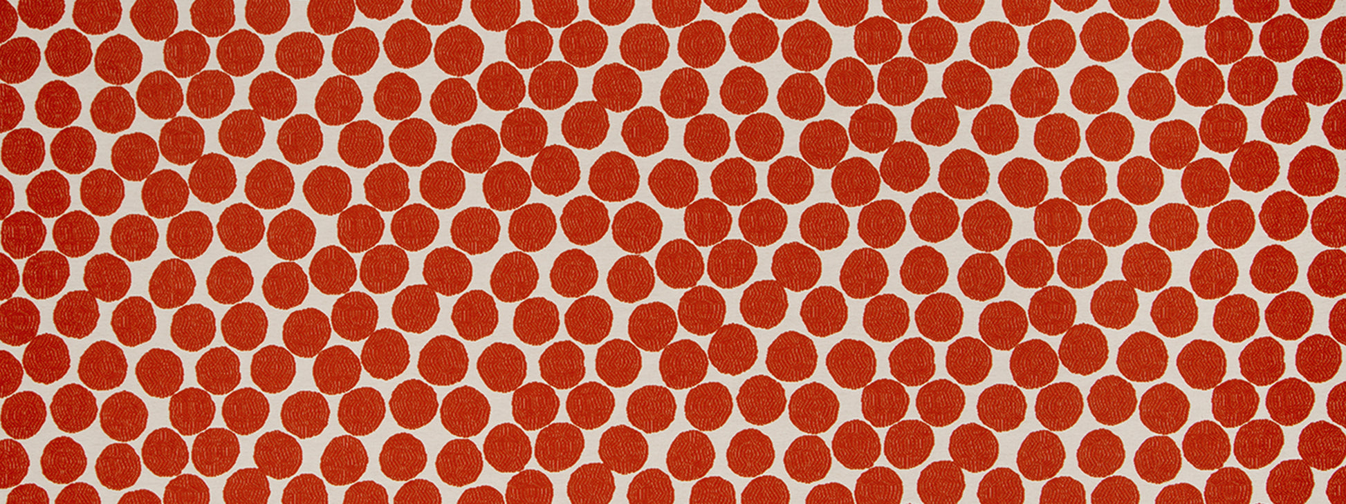 Close-up of orange polka dots on white background; bold, evenly spaced circular pattern.