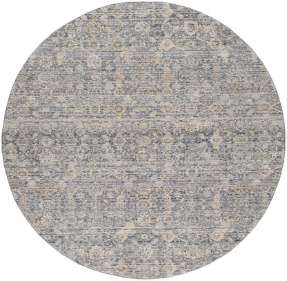 Round blue-gray rug with distressed vintage pattern of ivory floral medallions, soft and ornate.