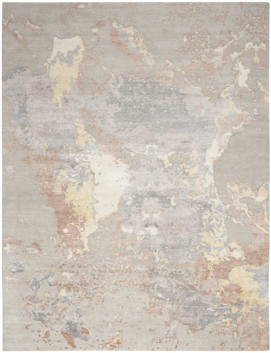 Abstract pastel area rug with muted beige, gray, ivory, pale yellow and pinks in a watercolor-style pattern.