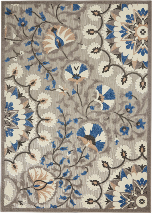 Beige floral area rug with blue, white and tan petals; large mandala blooms and winding vines.