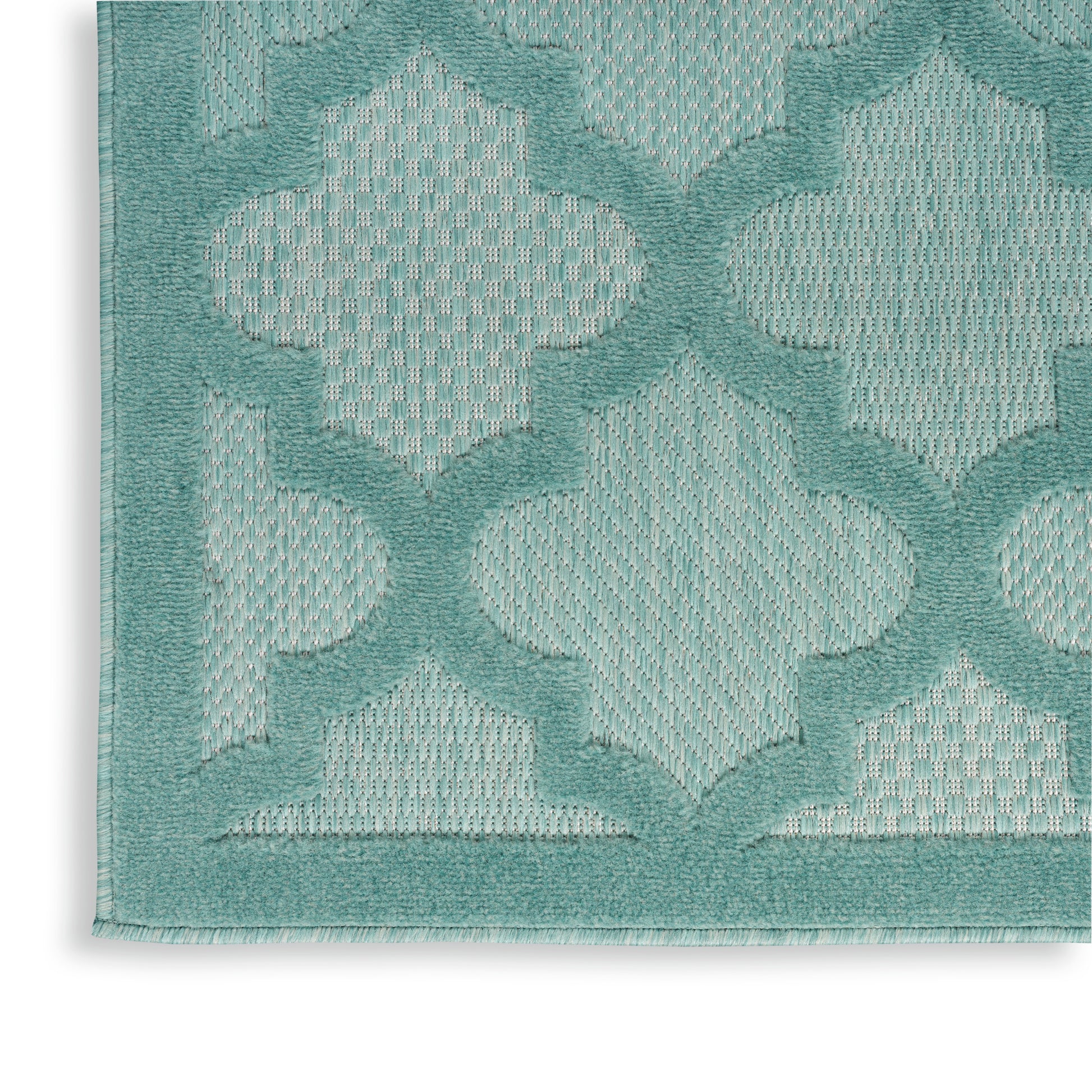 Teal geometric lattice rug with trellis/quatrefoil shapes, textured looped pile and teal border.