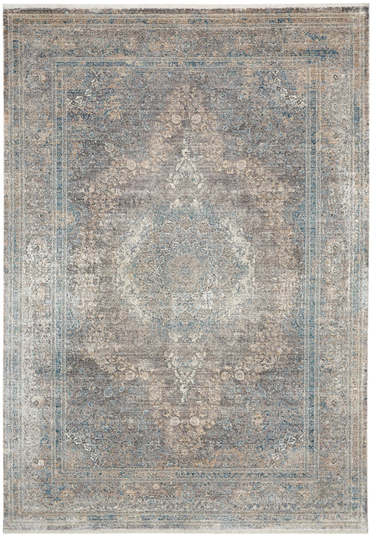 Rectangular distressed blue-beige oriental rug with central medallion and floral border; vintage-style living room decor.