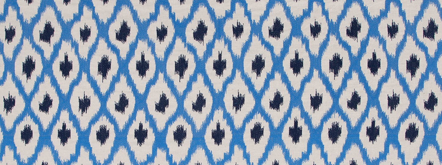 Blue and white ikat diamond-pattern textile with navy center accents.