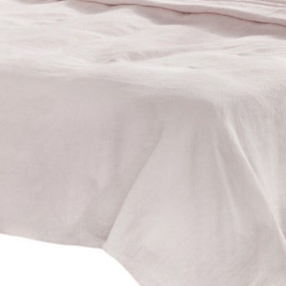 Soft light gray linen four-piece California King sheet set on a bed.