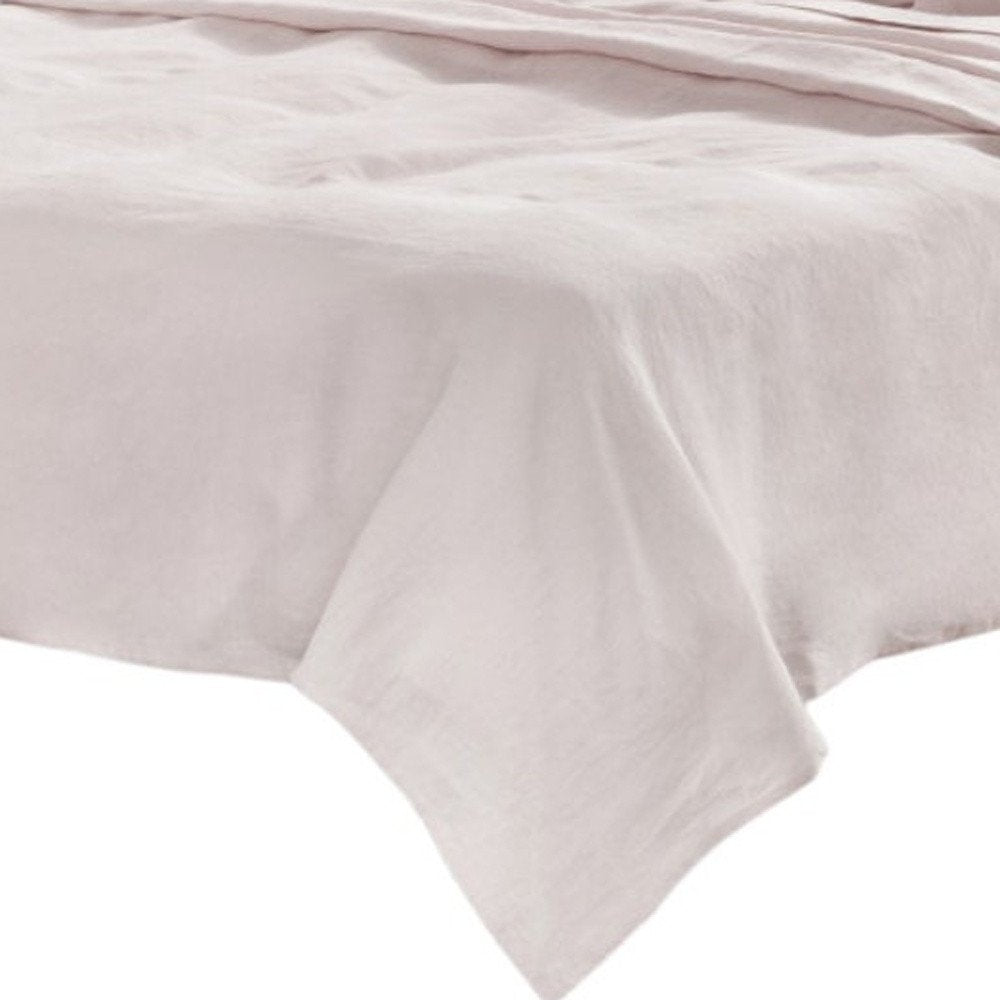 Light gray linen California King sheet set (four pieces) draped over the edge of a bed.