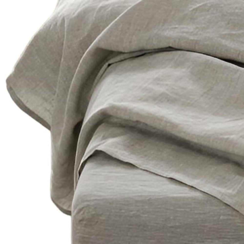 Light gray linen-look fabric draped in soft, layered folds for a minimalist, relaxed look.
